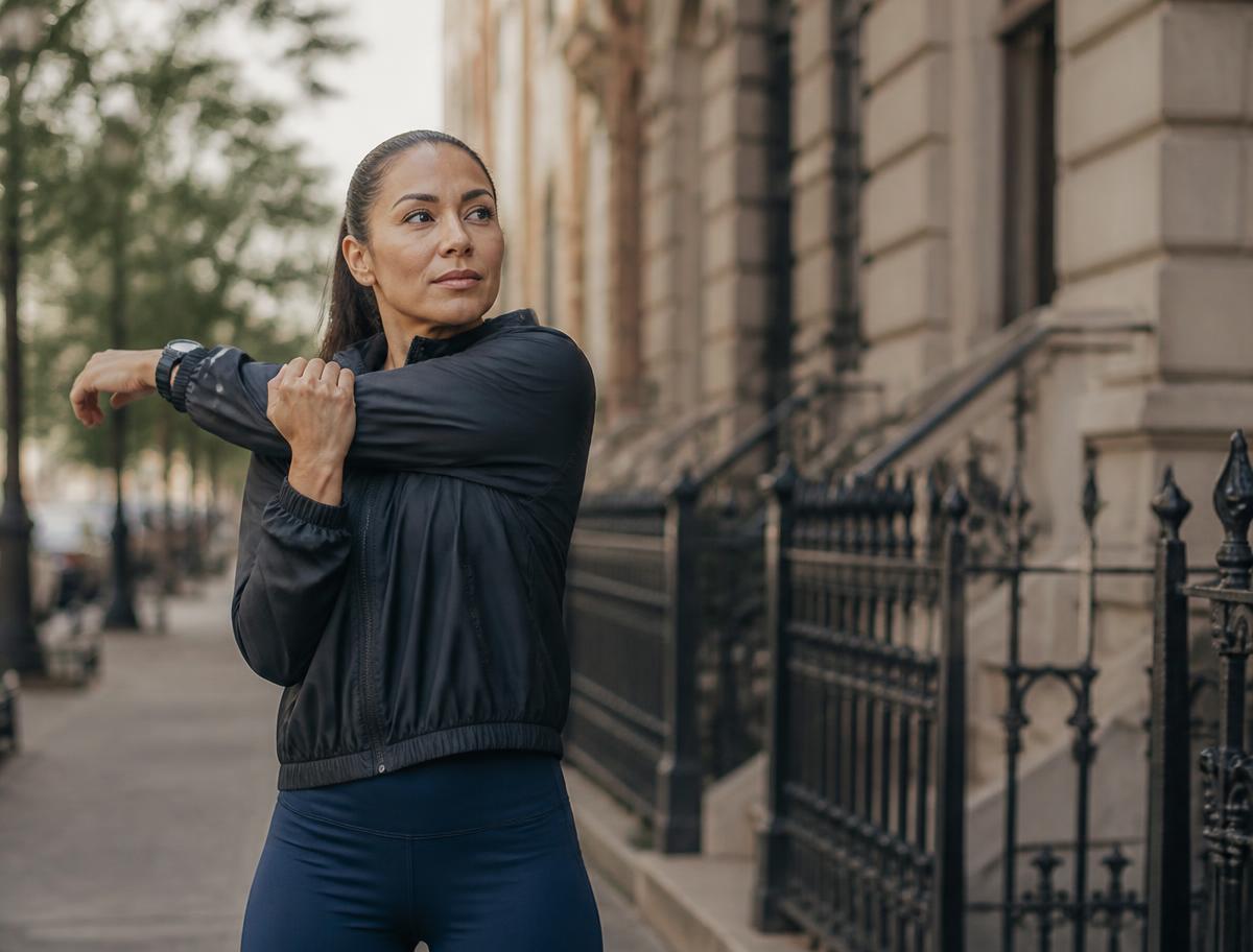 A member stretching after a morning run in the city